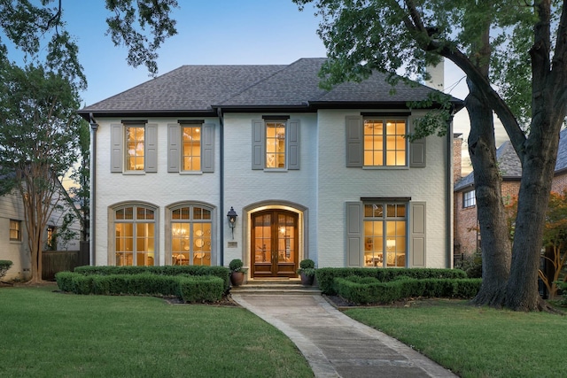 2905 Amherst Ave, University Park, TX 75225 - view of front of house with french doors, a front yard, and roof with shingles
