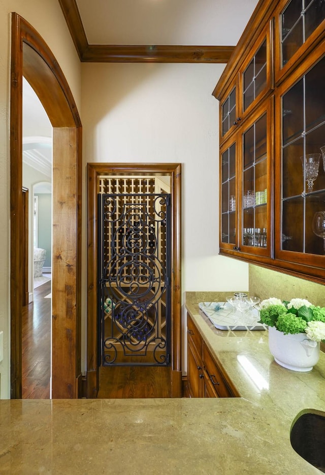 2905 Amherst Ave, University Park, TX 75225 - wine cellar with ornamental molding, arched walkways, and wood finished floors