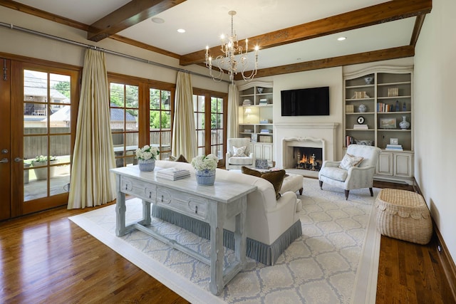 2905 Amherst Ave, University Park, TX 75225 - living area featuring a chandelier, beamed ceiling, wood finished floors, a warm lit fireplace, and built in features
