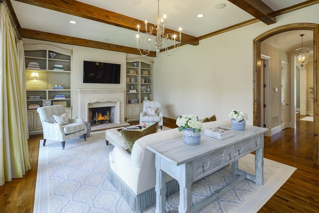 2905 Amherst Ave, University Park, TX 75225 - living room with beam ceiling, arched walkways, a premium fireplace, wood finished floors, and a chandelier