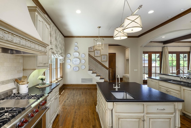 2905 Amherst Ave, University Park, TX 75225 - kitchen with a sink, cream cabinetry, dark countertops, high end stove, and crown molding