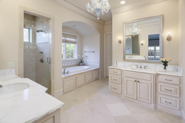 2905 Amherst Ave, University Park, TX 75225 - bathroom featuring ornamental molding, two vanities, a chandelier, a stall shower, and a garden tub