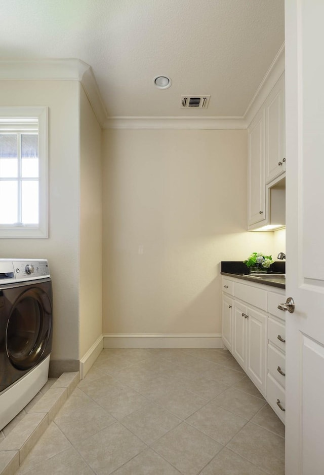 2905 Amherst Ave, University Park, TX 75225 - washroom with washer / dryer, ornamental molding, baseboards, light tile patterned floors, and cabinet space