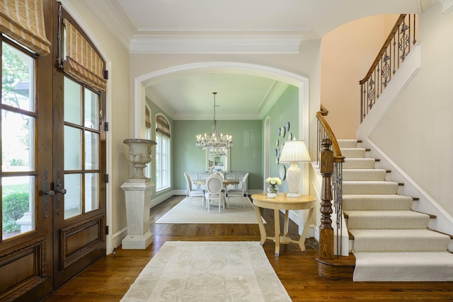 2905 Amherst Ave, University Park, TX 75225 - entryway with arched walkways, stairs, dark wood-style floors, ornamental molding, and a chandelier