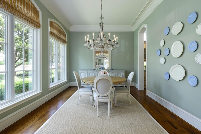 2905 Amherst Ave, University Park, TX 75225 - dining room with arched walkways, dark wood-style flooring, crown molding, baseboards, and a chandelier
