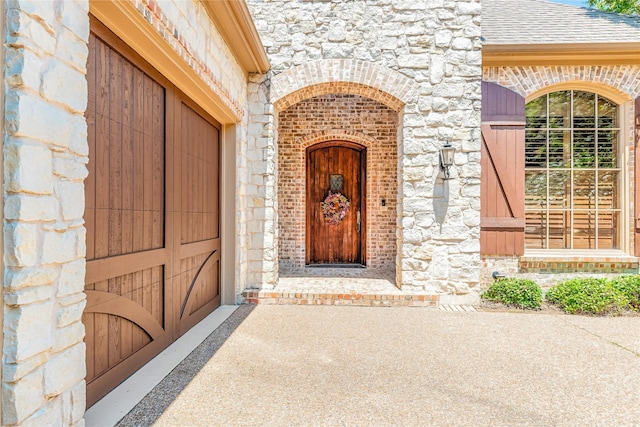 1420 Kensington Ct, Southlake, TX 76092 - property entrance featuring stone siding, a shingled roof, and brick siding