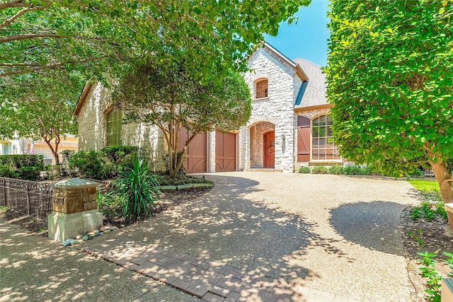 1420 Kensington Ct, Southlake, TX 76092 - view of front of home featuring stone siding, driveway, and roof with shingles