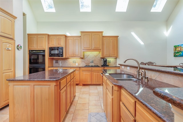1420 Kensington Ct, Southlake, TX 76092 - kitchen with a skylight, black appliances, a sink, tasteful backsplash, and dark stone counters