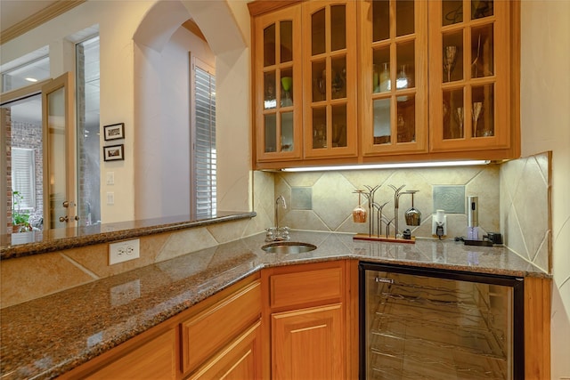 1420 Kensington Ct, Southlake, TX 76092 - kitchen featuring a sink, stone countertops, glass insert cabinets, and decorative backsplash