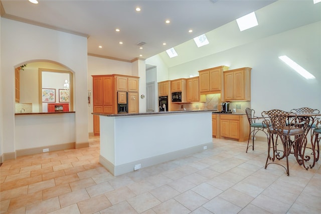 1420 Kensington Ct, Southlake, TX 76092 - kitchen with a skylight, black appliances, an island with sink, recessed lighting, and light tile patterned floors