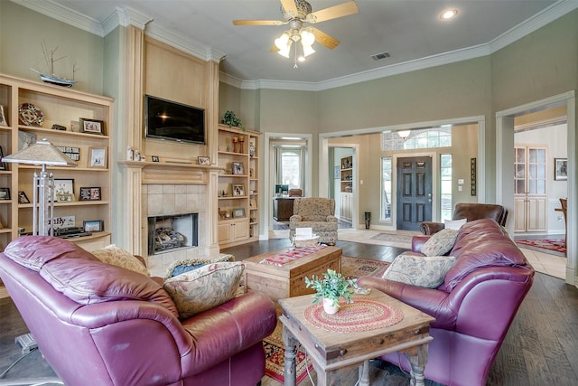 1717 Woodridge Ct, Aledo, TX 76008 - living room featuring ceiling fan, wood finished floors, a tiled fireplace, ornamental molding, and recessed lighting