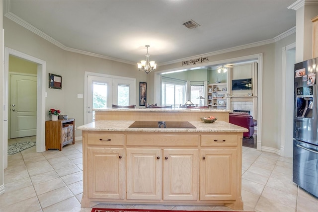 1717 Woodridge Ct, Aledo, TX 76008 - kitchen featuring stainless steel fridge, light brown cabinets, black electric cooktop, ornamental molding, and light tile patterned floors