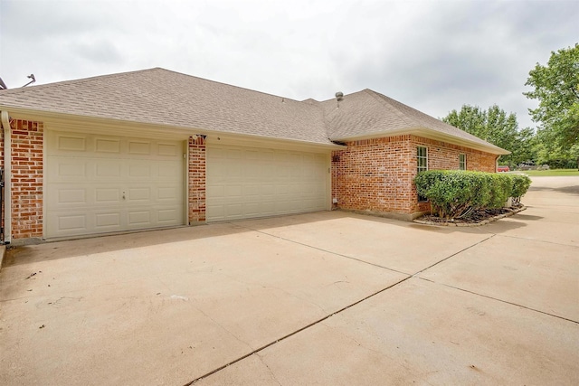 1717 Woodridge Ct, Aledo, TX 76008 - view of side of home with brick siding, driveway, an attached garage, and roof with shingles