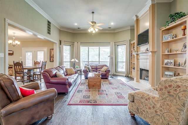 1717 Woodridge Ct, Aledo, TX 76008 - living area with ceiling fan, wood finished floors, a tiled fireplace, a chandelier, and crown molding