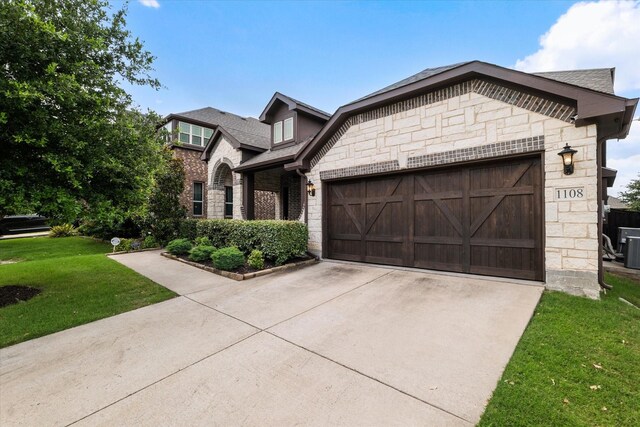 1108 Summer Ln, Mckinney, TX 75071 - view of front facade featuring stone siding, a garage, driveway, a front lawn, and brick siding