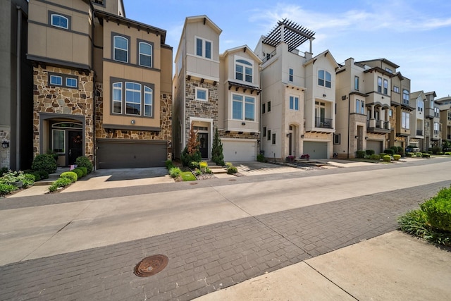 1844 Stevens Bluff Ln, Dallas, TX 75208 - view of front of property with stone siding, a residential view, driveway, a garage, and stucco siding