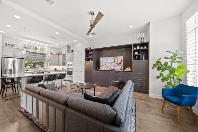 1844 Stevens Bluff Ln, Dallas, TX 75208 - living room featuring light wood-style flooring, ceiling fan, recessed lighting, and baseboards