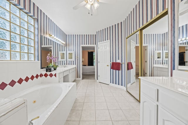205 Lovegrass Ln, Southlake, TX 76092 - full bath featuring wallpapered walls, a whirlpool tub, a ceiling fan, vanity, and tile patterned flooring