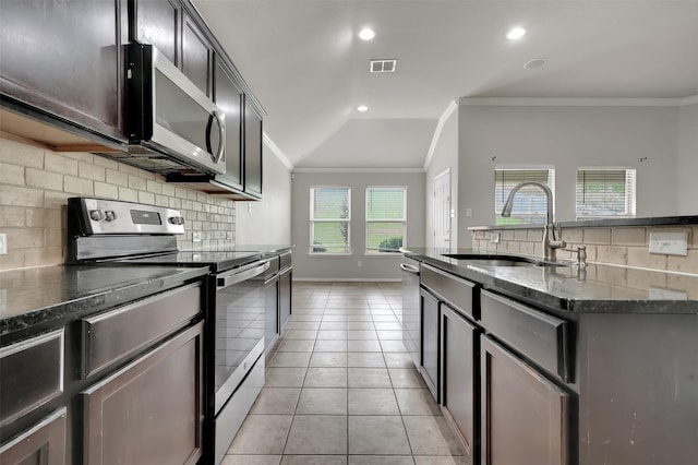 1209 Evers Dr, Mckinney, TX 75071 - kitchen with stainless steel appliances, ornamental molding, a sink, decorative backsplash, and dark stone counters