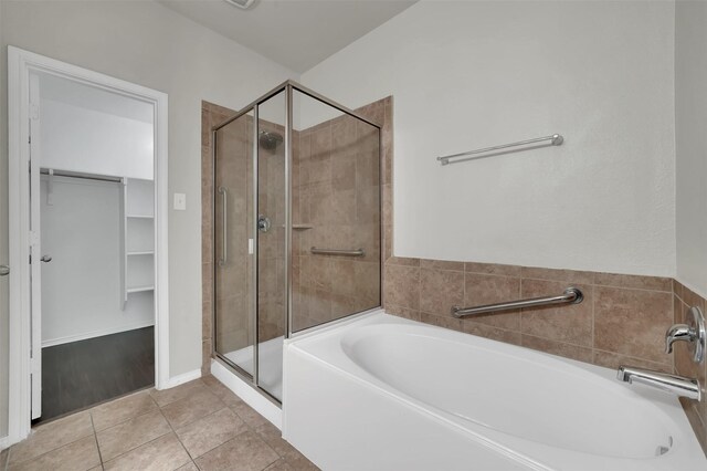 1209 Evers Dr, Mckinney, TX 75071 - bathroom with a garden tub, a shower stall, a spacious closet, and tile patterned flooring