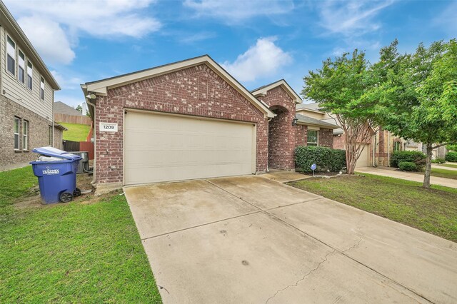 1209 Evers Dr, Mckinney, TX 75071 - view of front facade with brick siding, concrete driveway, a front yard, and a garage