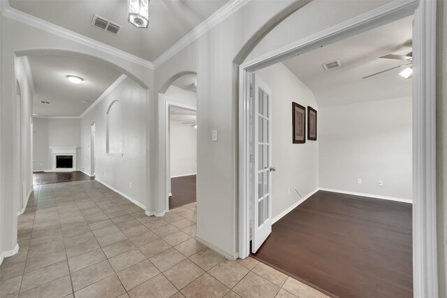 1209 Evers Dr, Mckinney, TX 75071 - hall with crown molding, arched walkways, light tile patterned floors, and baseboards