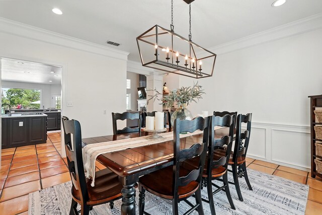 99 Glen Abbey St, Abilene, TX 79606 - dining room with crown molding, light tile patterned floors, a chandelier, a wainscoted wall, and recessed lighting
