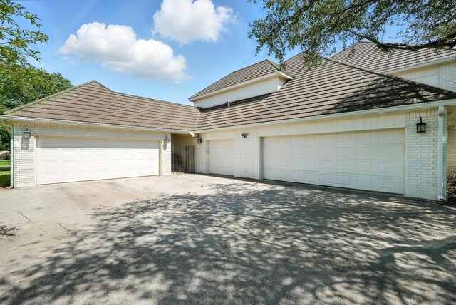 99 Glen Abbey St, Abilene, TX 79606 - view of front of property with brick siding, a garage, and driveway