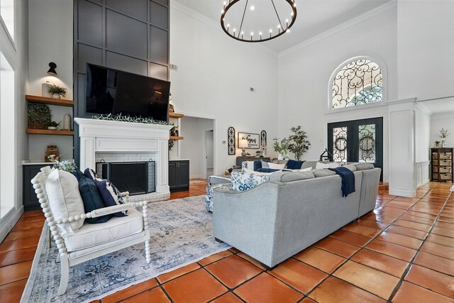 99 Glen Abbey St, Abilene, TX 79606 - living area featuring a high ceiling, crown molding, a chandelier, a fireplace, and light tile patterned flooring