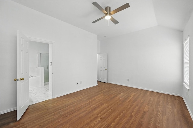 6609 Adobe Cir, The Colony, TX 75056 - unfurnished bedroom with wood finished floors, baseboards, multiple windows, lofted ceiling, and ensuite bath