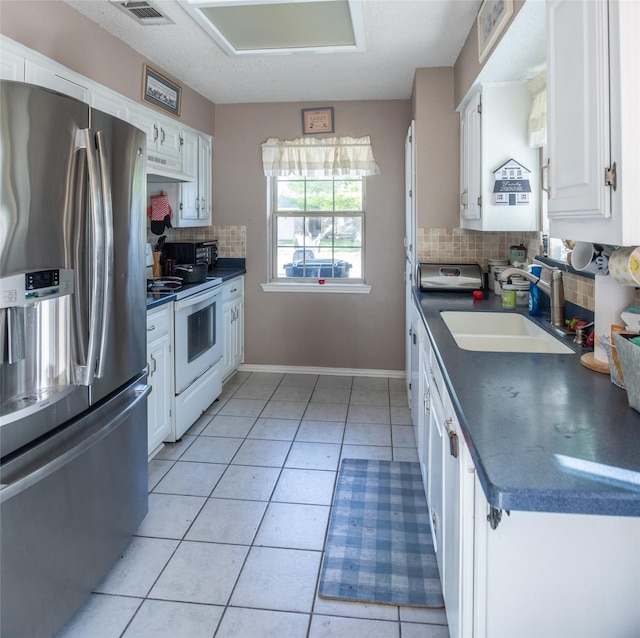 3506 Bryan St, Sachse, TX 75048 - kitchen featuring stainless steel fridge, white electric stove, a sink, and dark countertops