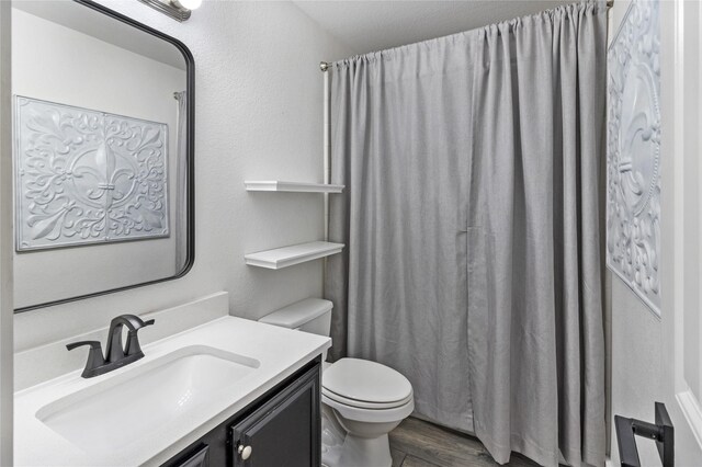 990 Lancashire Ln, Prosper, TX 75078 - full bath with vanity, toilet, wood finished floors, and a shower with shower curtain