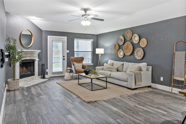 990 Lancashire Ln, Prosper, TX 75078 - living area featuring ceiling fan, wood finished floors, a high end fireplace, a textured wall, and baseboards