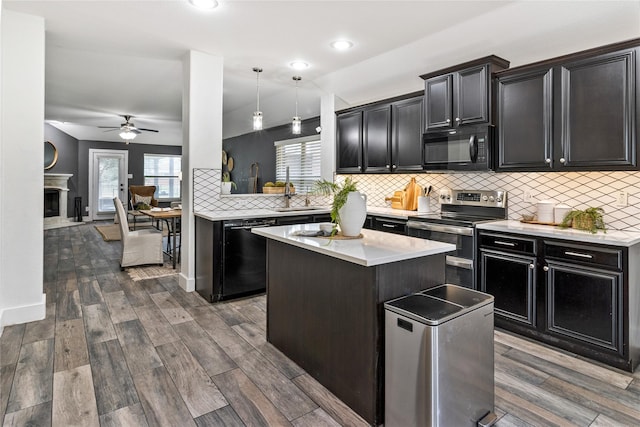 990 Lancashire Ln, Prosper, TX 75078 - kitchen featuring black appliances, dark cabinets, a sink, ceiling fan, and a kitchen island