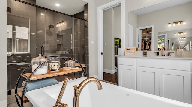 8162 Edgefield Ct, Frisco, TX 75035 - full bath featuring a soaking tub, a stall shower, vanity, wood finished floors, and recessed lighting