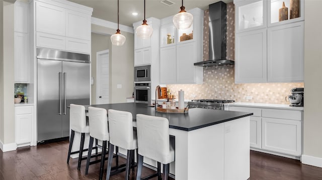 8162 Edgefield Ct, Frisco, TX 75035 - kitchen with built in appliances, wall chimney exhaust hood, backsplash, dark countertops, and dark wood-type flooring