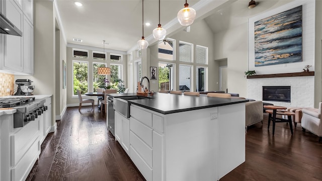 8162 Edgefield Ct, Frisco, TX 75035 - kitchen featuring appliances with stainless steel finishes, dark wood-type flooring, open floor plan, dark countertops, and recessed lighting