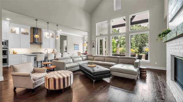 8162 Edgefield Ct, Frisco, TX 75035 - living room featuring high vaulted ceiling, dark wood-style floors, a brick fireplace, and recessed lighting