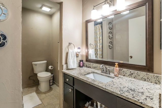 1001 N Ector Dr, Euless, TX 76039 - full bathroom with toilet, vanity, baseboards, and tile patterned flooring