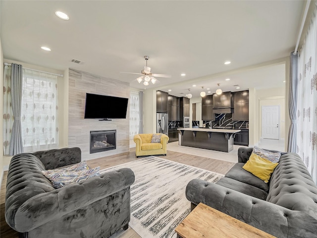1019 Devonshire Dr, Allen, TX 75013 - living area featuring a fireplace, a ceiling fan, recessed lighting, and light wood-style flooring