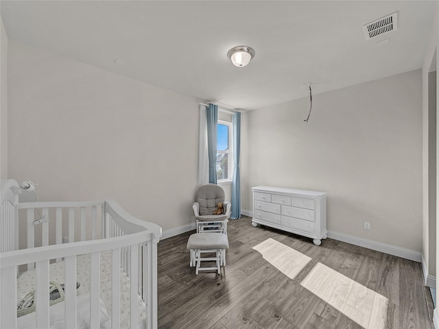 1019 Devonshire Dr, Allen, TX 75013 - bedroom featuring wood finished floors, baseboards, and a nursery area