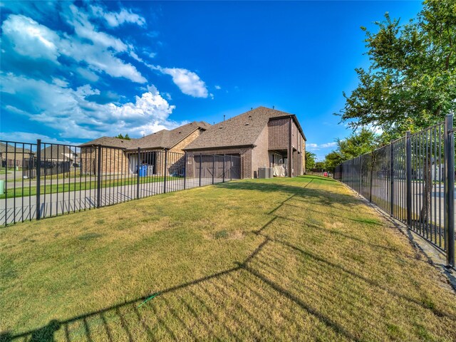 1019 Devonshire Dr, Allen, TX 75013 - back of property featuring concrete driveway, a garage, brick siding, and central AC
