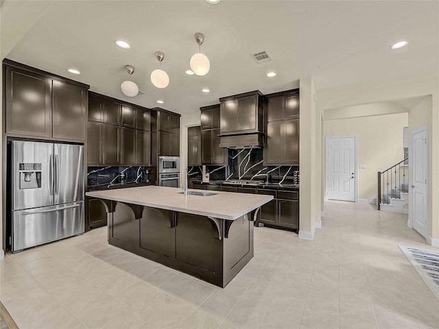 1019 Devonshire Dr, Allen, TX 75013 - kitchen with appliances with stainless steel finishes, a sink, tasteful backsplash, recessed lighting, and a kitchen bar