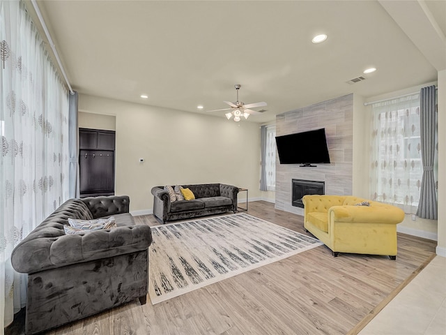 1019 Devonshire Dr, Allen, TX 75013 - living room with plenty of natural light, recessed lighting, a tiled fireplace, and baseboards