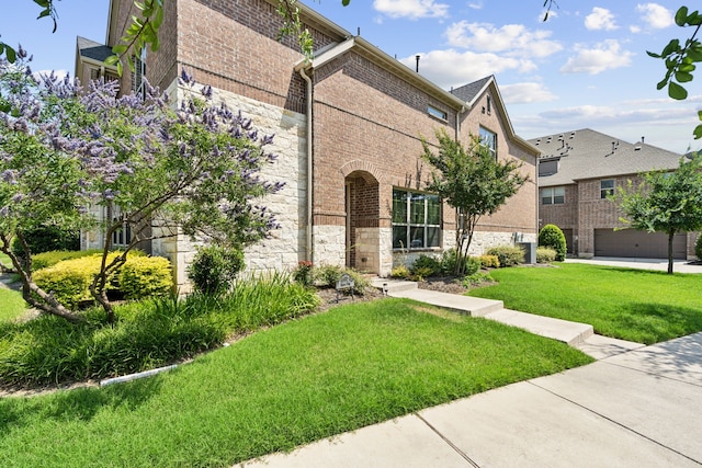 4682 Rhett Ln Unit A, Carrollton, TX 75010 - view of front of house with stone siding, a front lawn, and brick siding