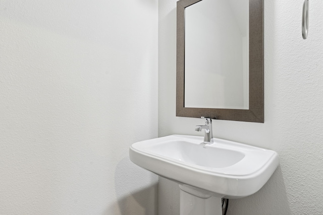4682 Rhett Ln Unit A, Carrollton, TX 75010 - bathroom featuring a sink and a textured wall