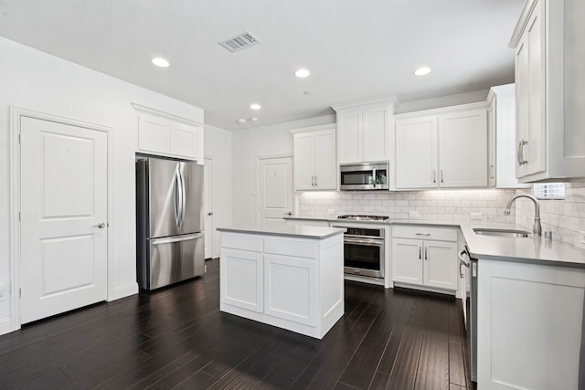 4682 Rhett Ln Unit A, Carrollton, TX 75010 - kitchen with appliances with stainless steel finishes, a sink, backsplash, white cabinets, and recessed lighting