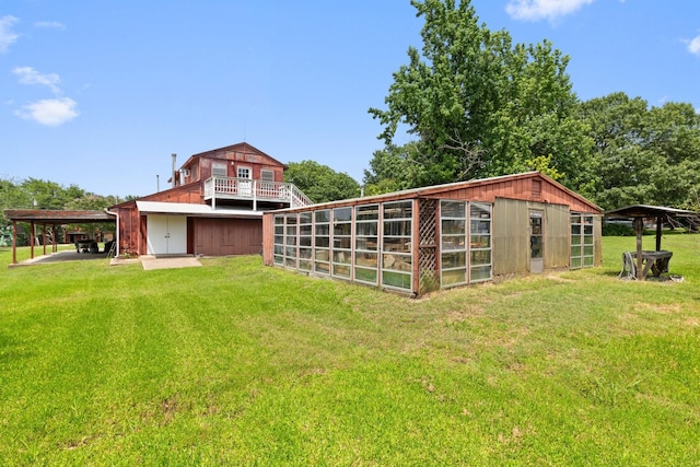 891 Lazy Acres Cir, Pottsboro, TX 75076 - back of house featuring a carport, an outdoor structure, and a yard