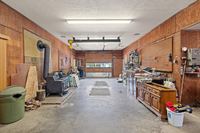 891 Lazy Acres Cir, Pottsboro, TX 75076 - garage with wood walls and a wood stove