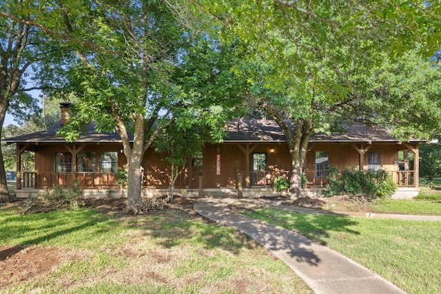 891 Lazy Acres Cir, Pottsboro, TX 75076 - view of front facade with covered porch, a front yard, and a chimney